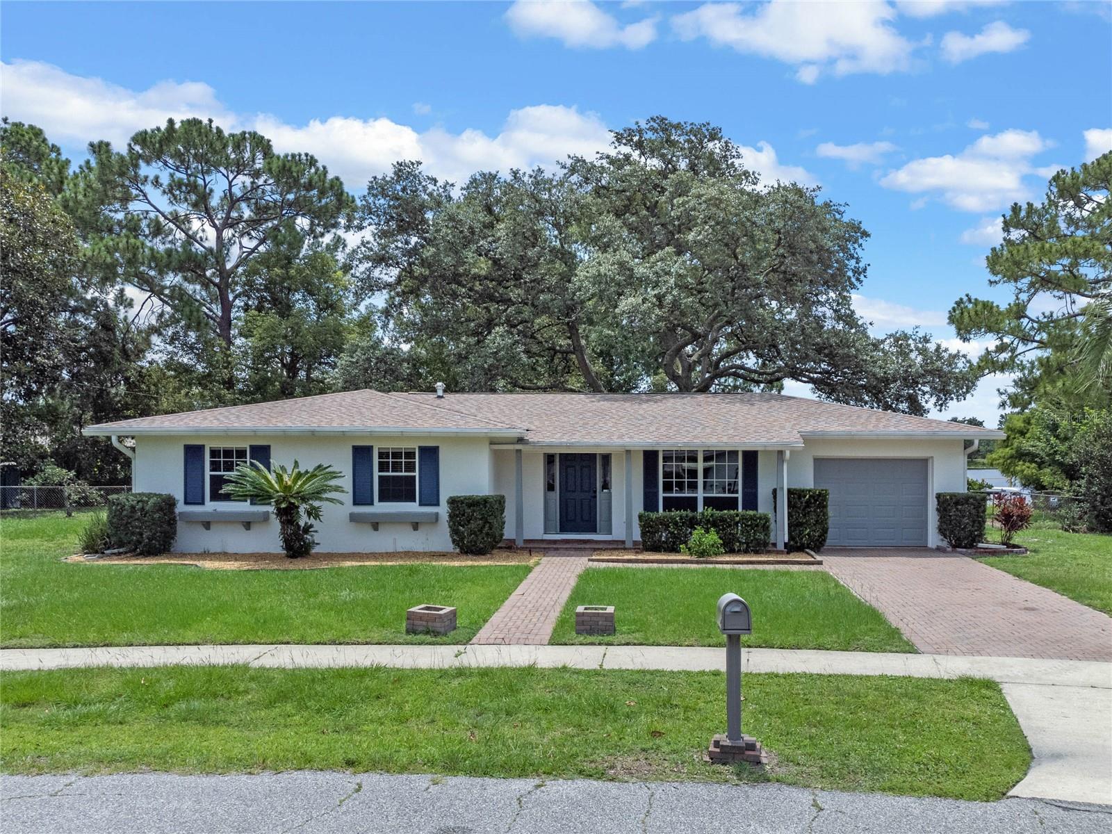 Front view of 1493 Hancock Drive, Deltona, FL - FRESH EXTERIOR PAINT, BRICK PAVED DRIVEWAY, WALKWAY &amp; FRONT PORCH!