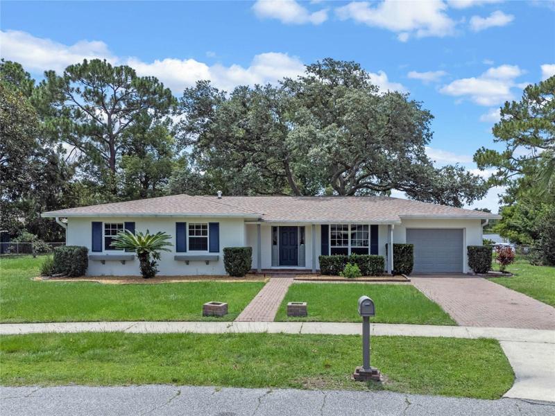 Front view of 1493 Hancock Drive, Deltona, FL - FRESH EXTERIOR PAINT, BRICK PAVED DRIVEWAY, WALKWAY & FRONT PORCH!