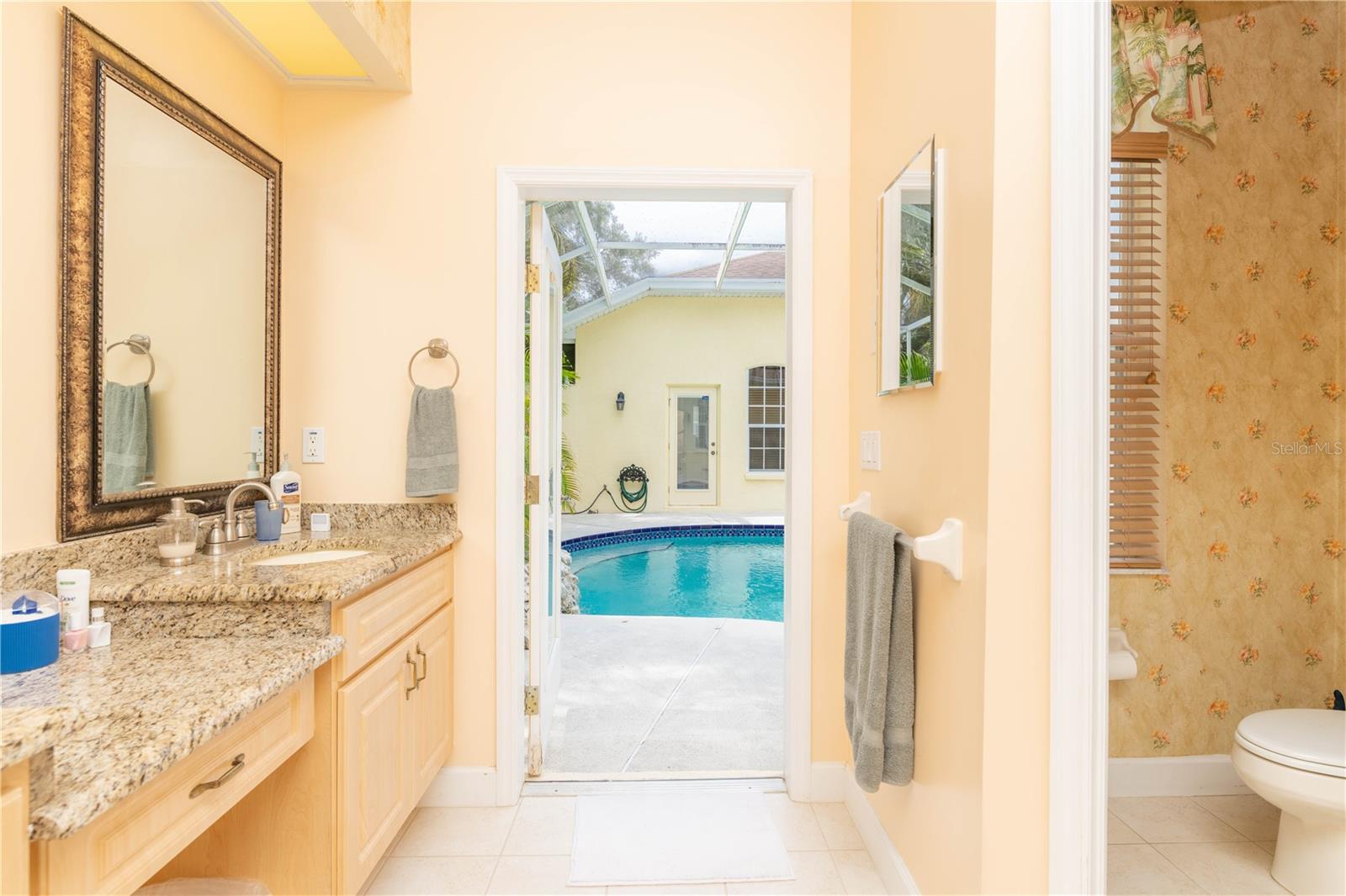 Master bathroom leading to pool