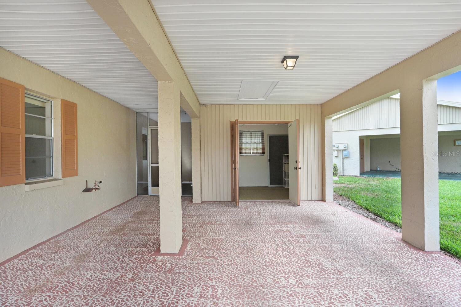Car Port view of storage room or golf cart parking