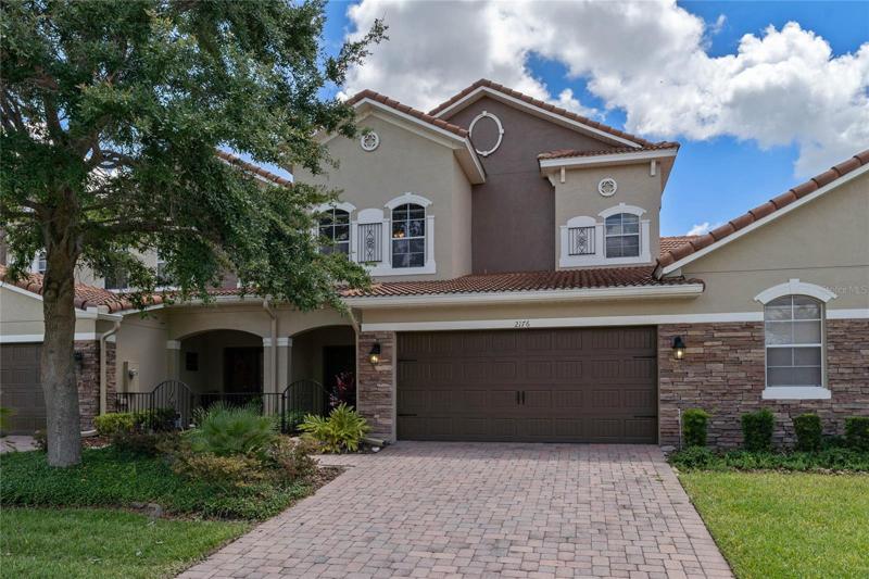 Exterior view, stone accents, tile roof and pavers