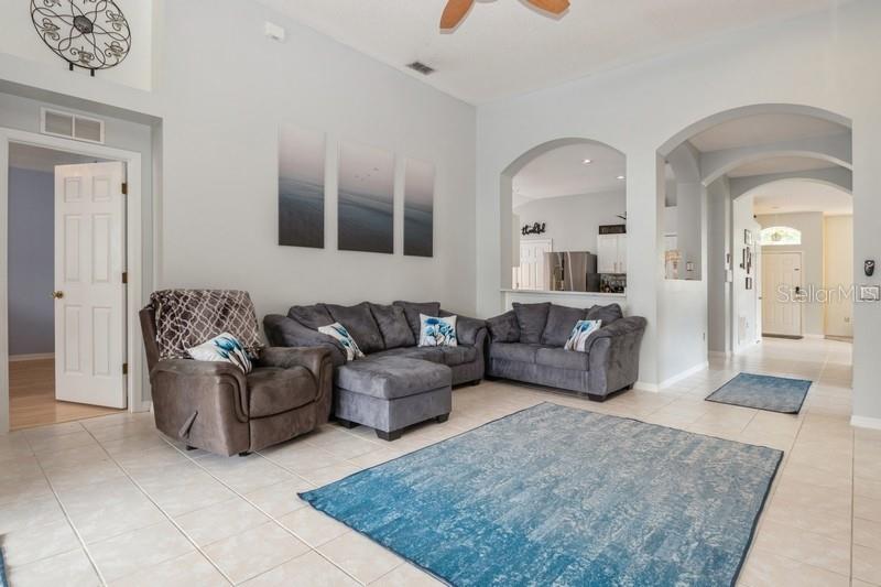 Family room, door in center to den/office/guest bedroom with closet, hall bath at right between bedrooms