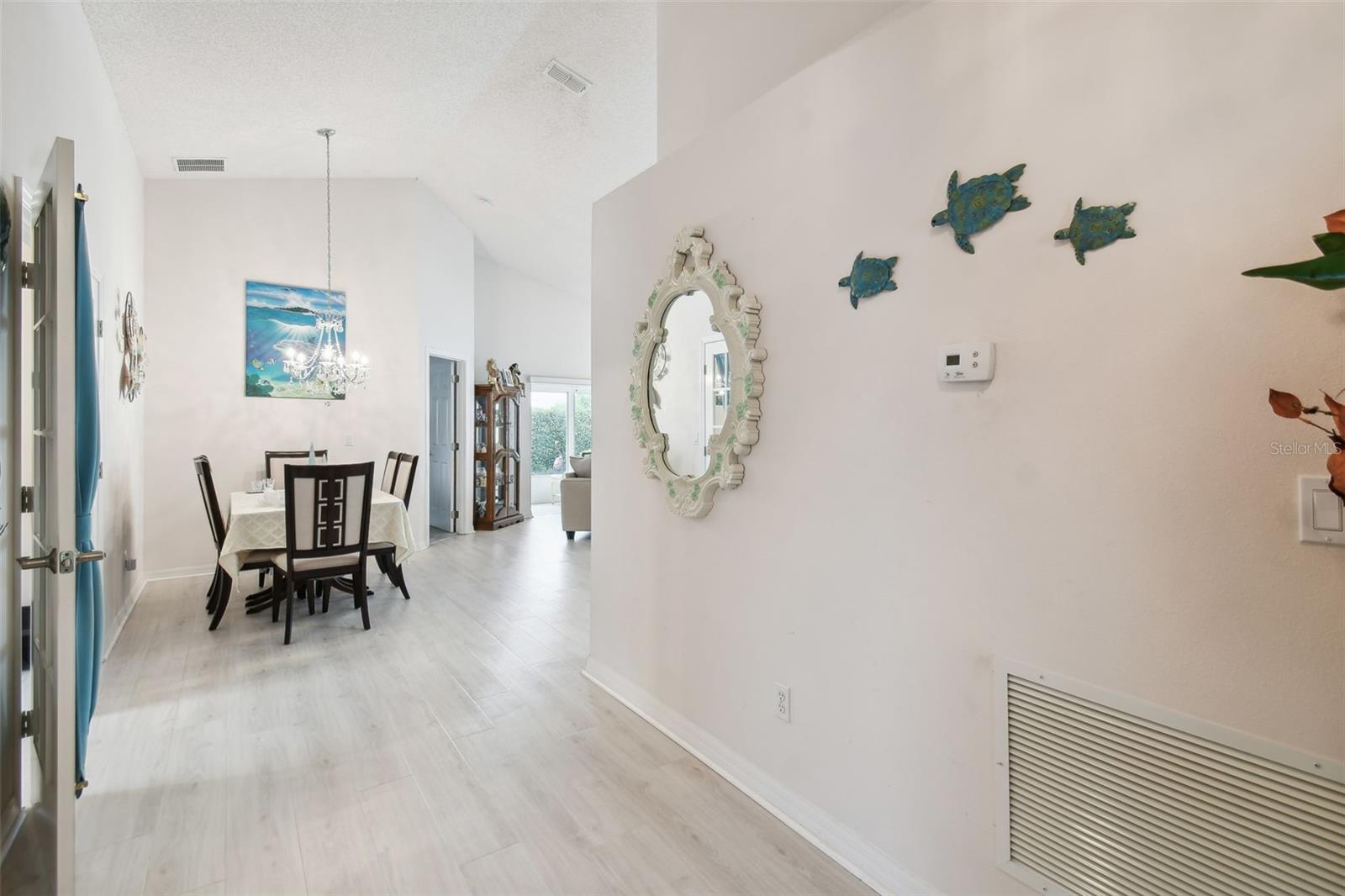 Foyer opens to den and dining area
