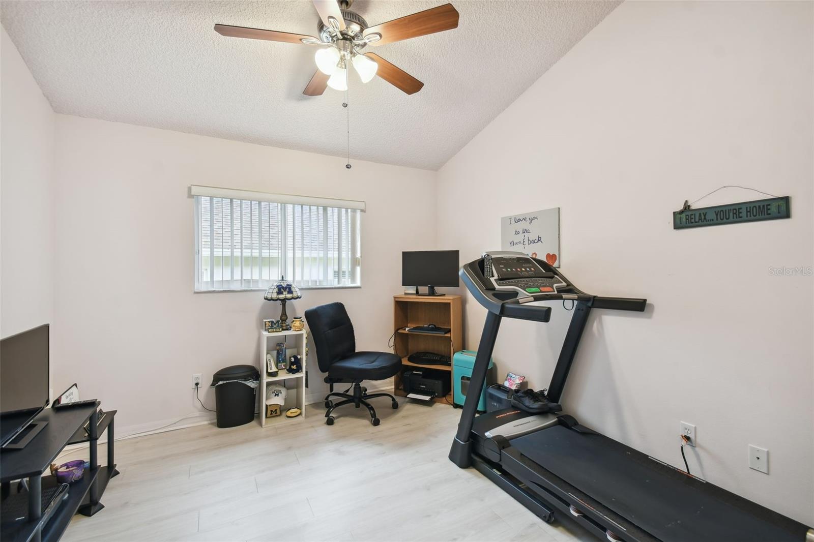 Vaulted ceiling and a window bring the natural light in and the fan will keep you cool during your workout