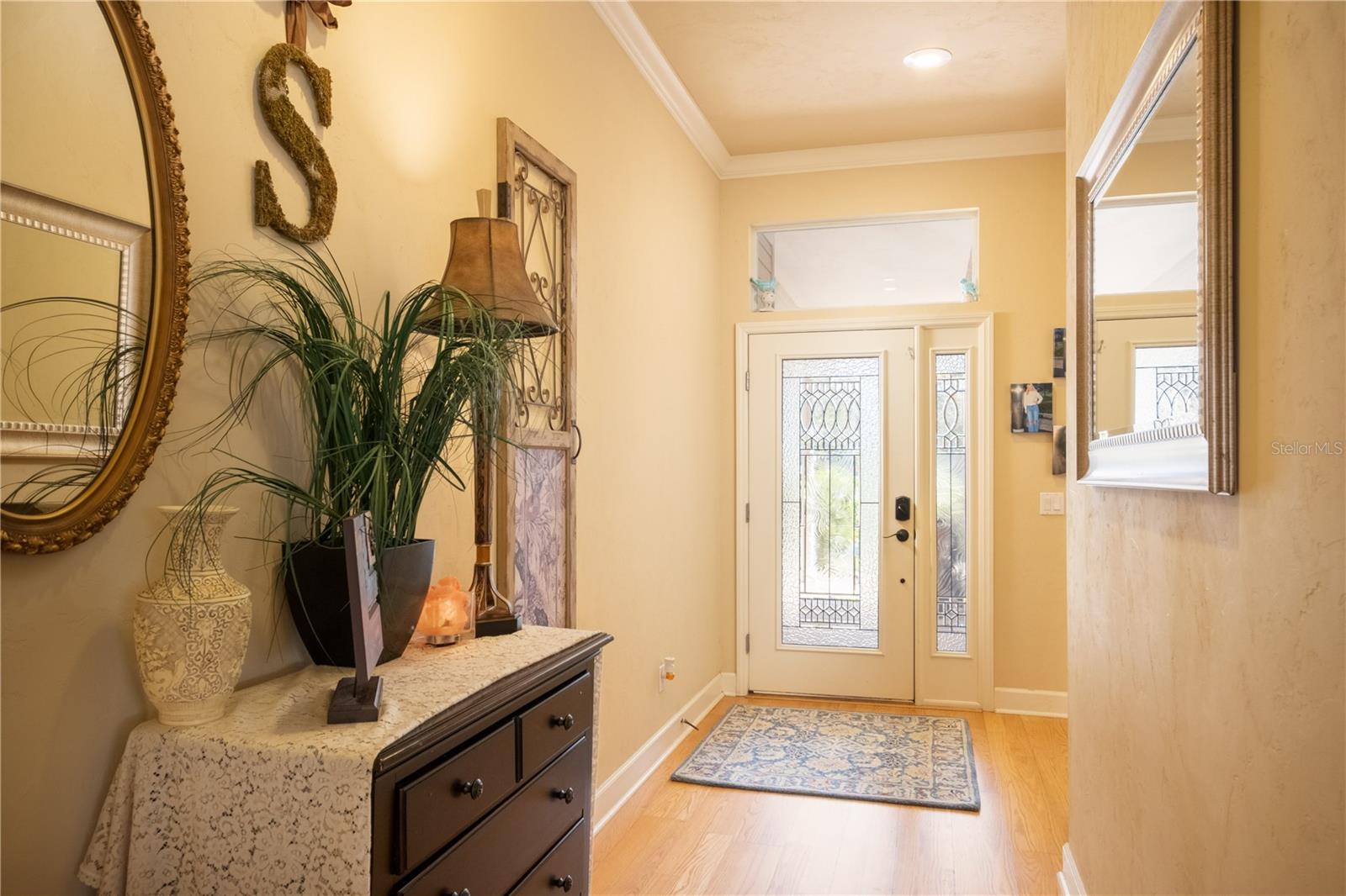 LONG FOYER FEATURING LEADED GLASS FRONT DOORS