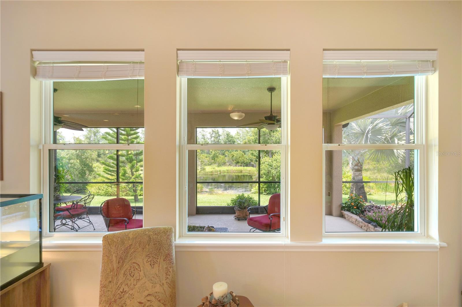 Beautiful views from the great room out to the covered atrium and conservation area backyard
