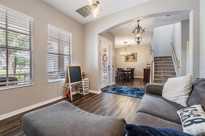 Living room at front of house; view to dining room