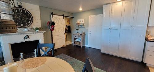 entrance area  barn door on utility room extra storage cabinets in kitchen area