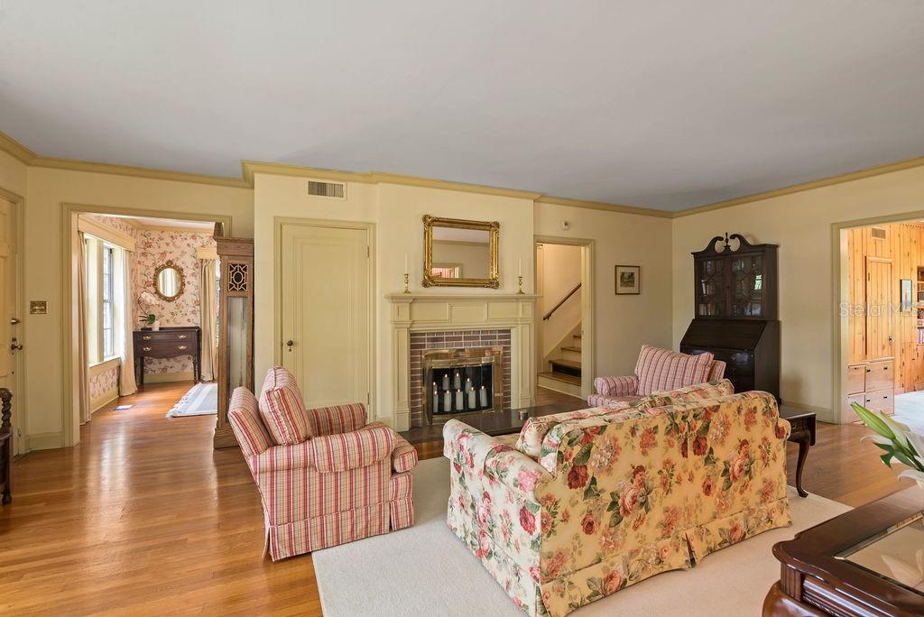 Living room with view into the dining room and office.