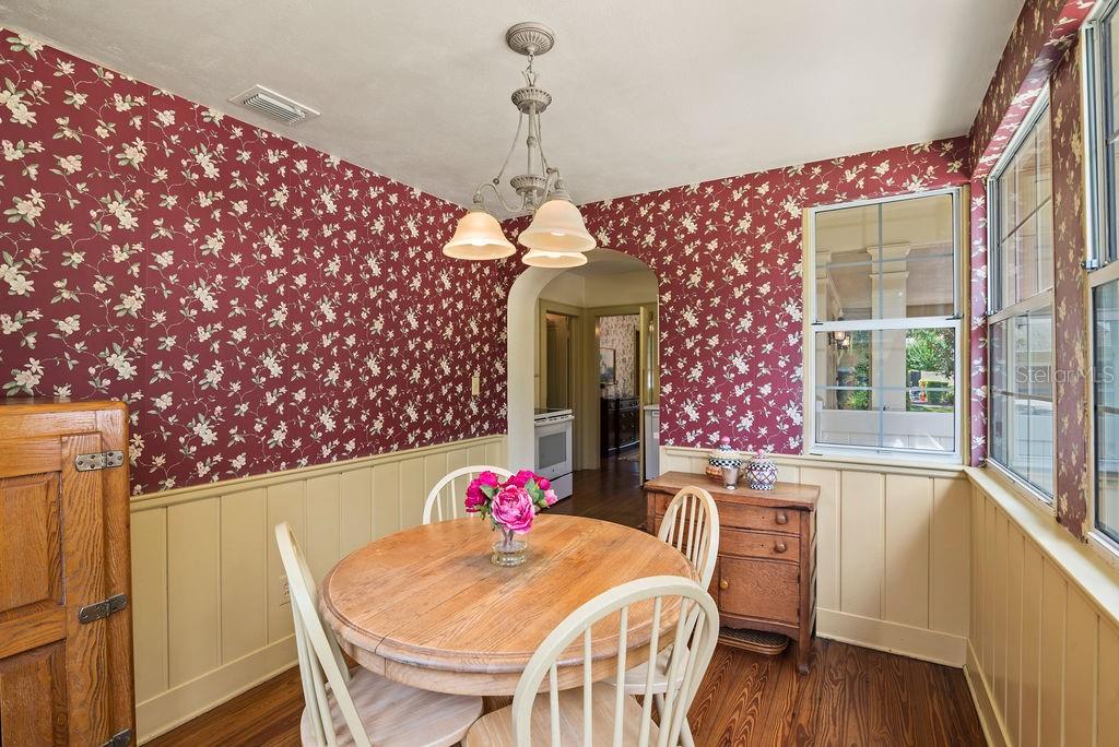 Adorable breakfast nook with wainscoting and arched entry