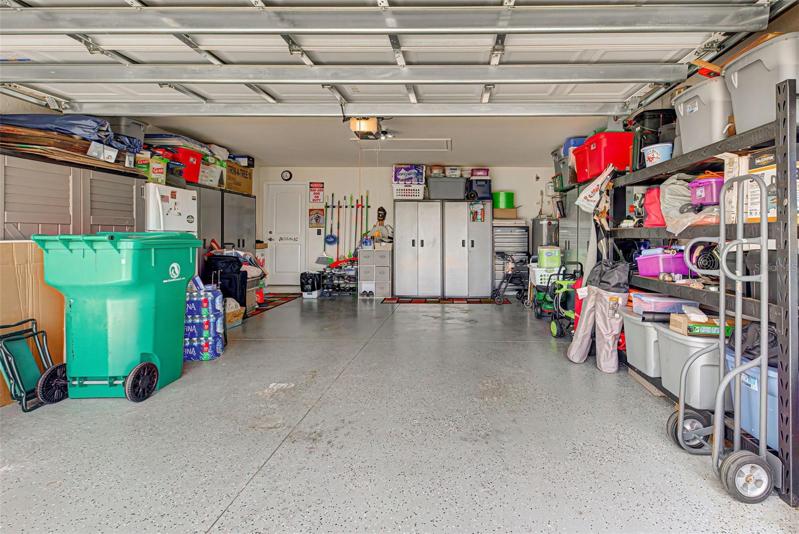 2 car garage with storage space and partially floored atic