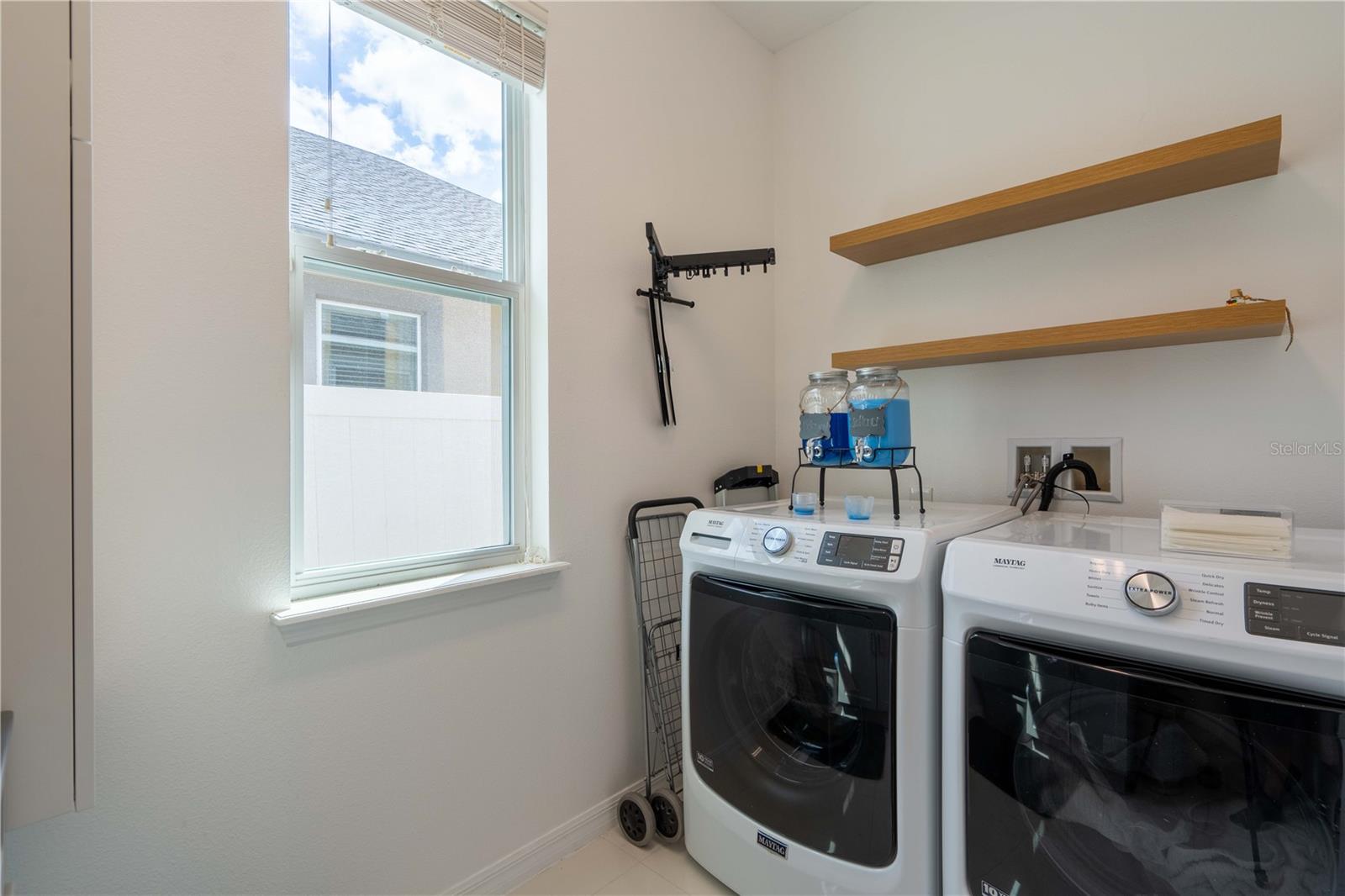 Laundry Room with cabinets, shelving, and basin