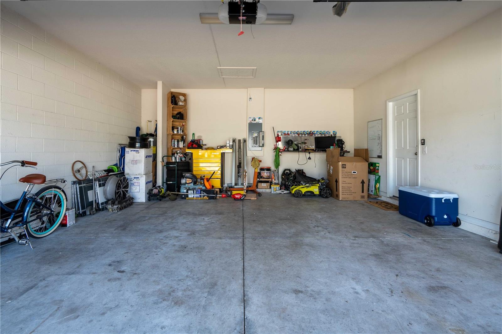 2-car garage with tool shelving and overhead storage rack