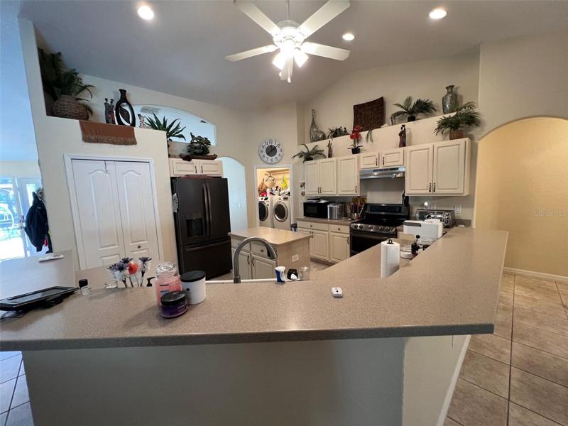 Full kitchen with island and bar seating