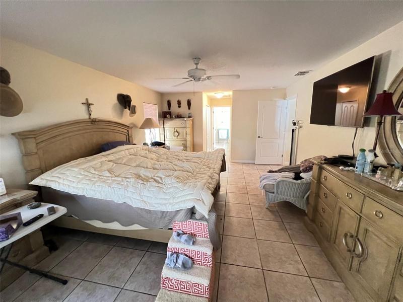 Master bedroom with his and her closets