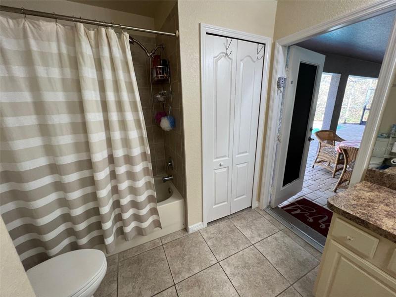 Tiled shower with tub that goes out to the lanai