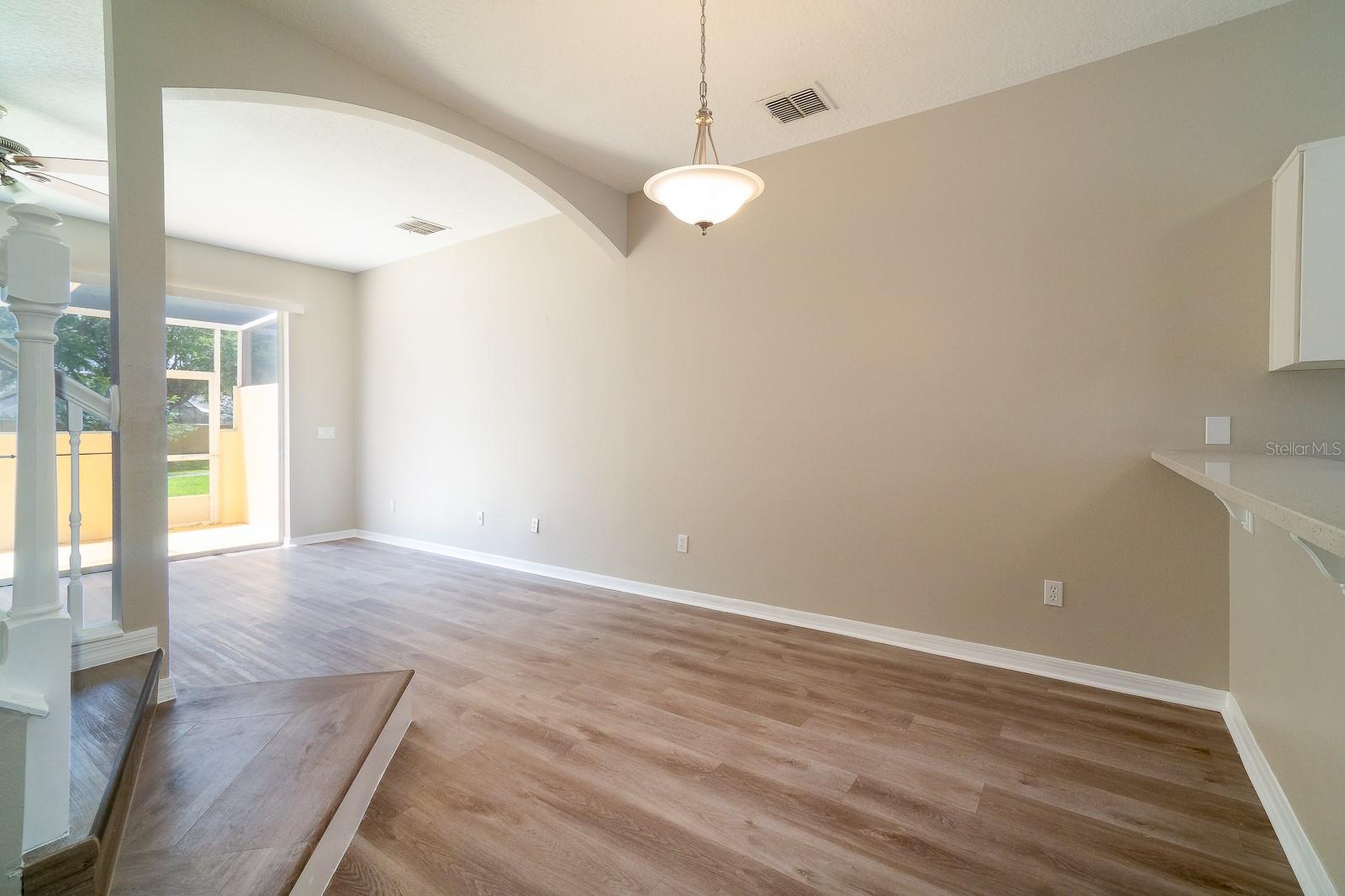 The kitchen seamlessly flows into the great room, which features a dedicated dining area and a spacious living area.
