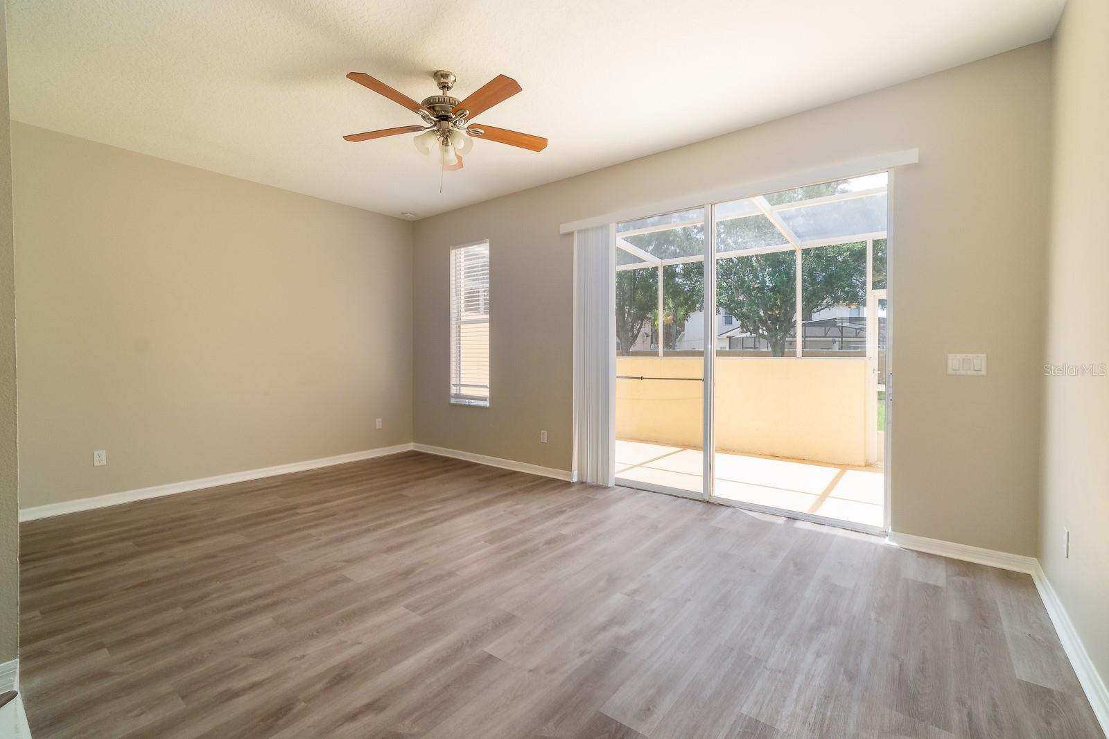 Sliding glass doors lead out to the screened patio, allowing for indoor-outdoor living and providing a perfect spot to relax or entertain.