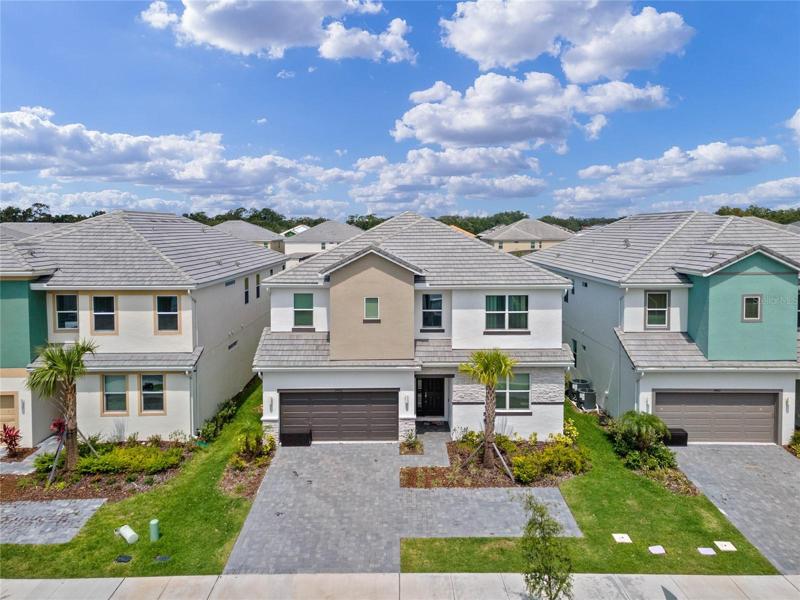 Built in 2022, this stunning practically **BRAND NEW VACATION HOME** offers breathtaking POND VIEWS and is located in the highly sought-after GUARD GATED Veranda Palms community in the beautiful city of Kissimmee!