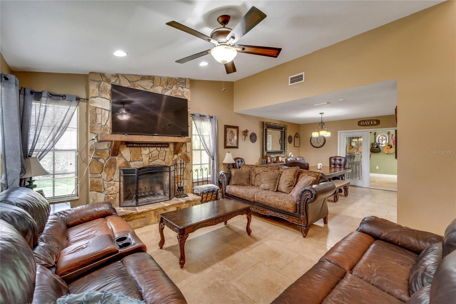 living area with stone wall fireplace