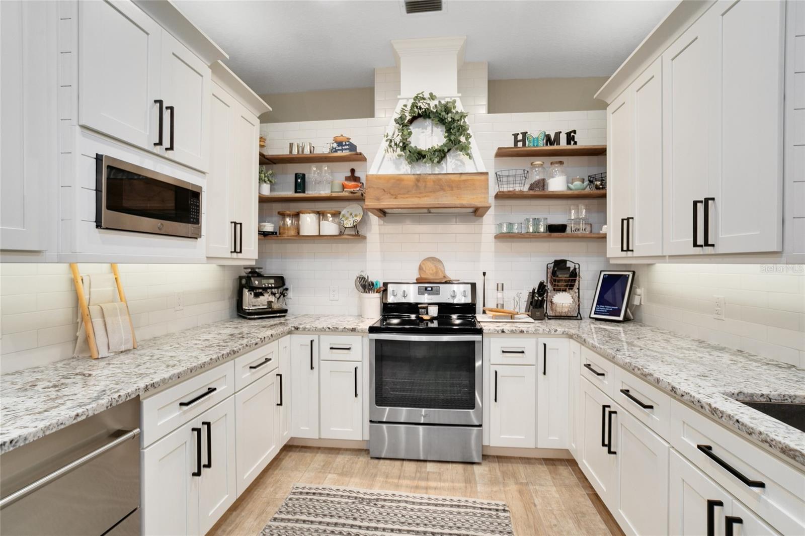 Hand Crafted Range hood sets off the high end kitchen finishes