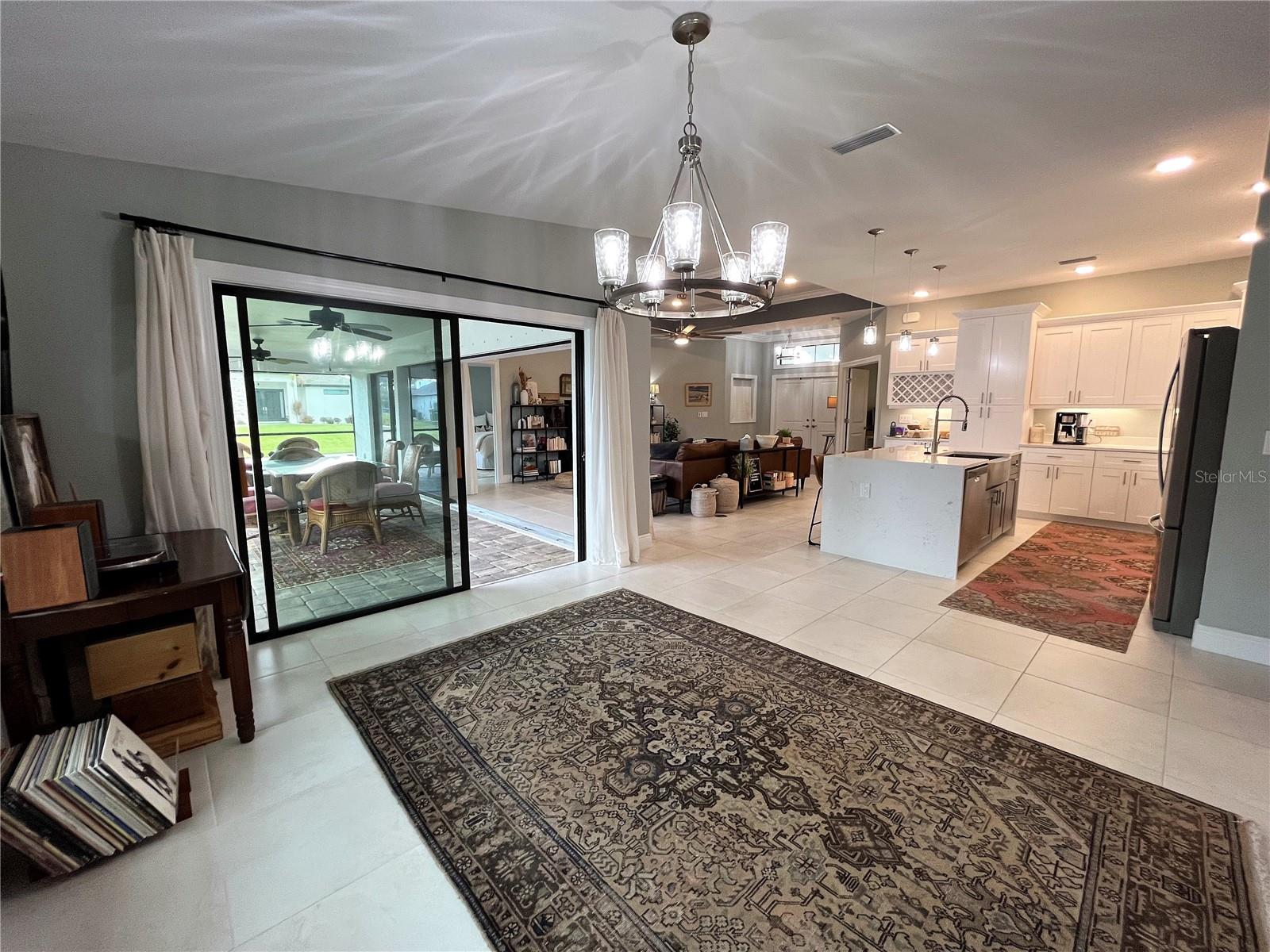 Dining room has sliding door to the lanai/pool