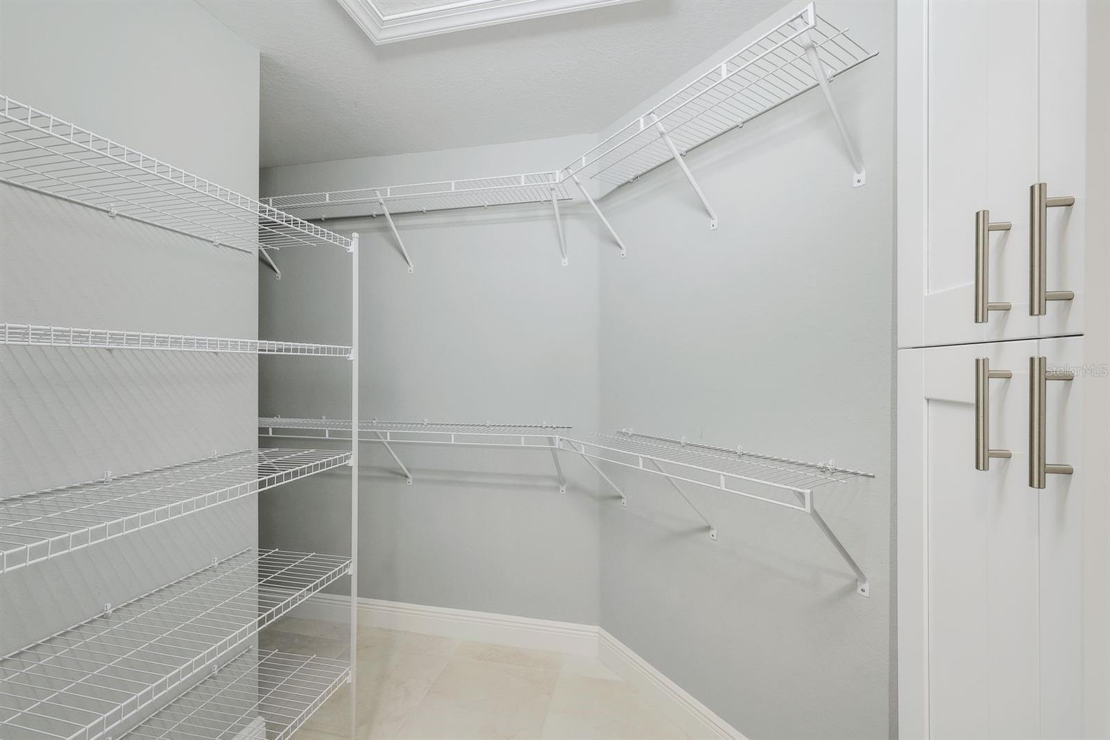 Huge Owner's Suite walk-in closet with cabinet and lots of hanging space (too much to see here)