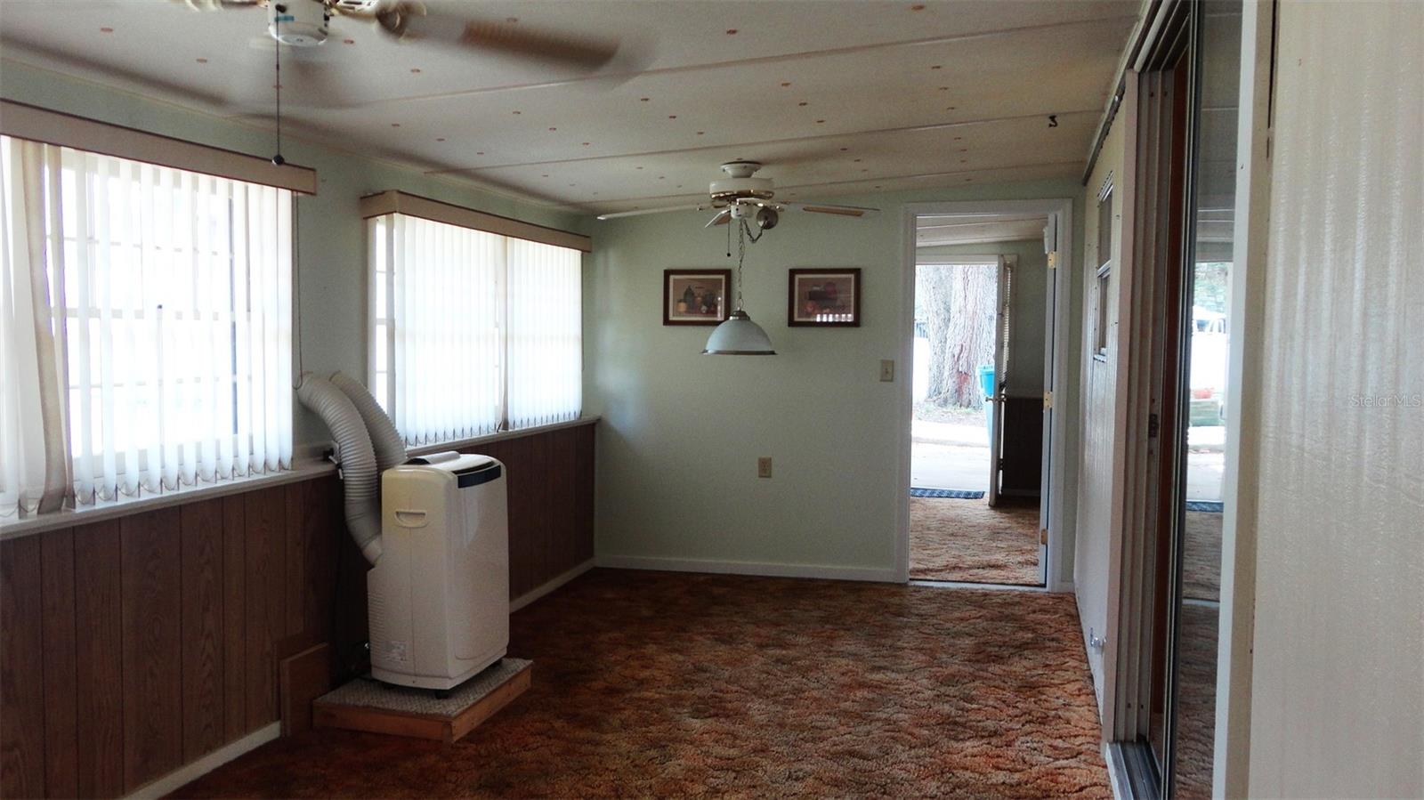 Finished enclosed porch with self-contained AC unit.