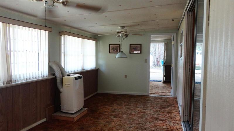 Finished enclosed porch with self-contained AC unit.