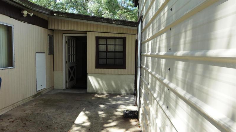 Two hundred square foot patio area between driveway, back door and workshop.
