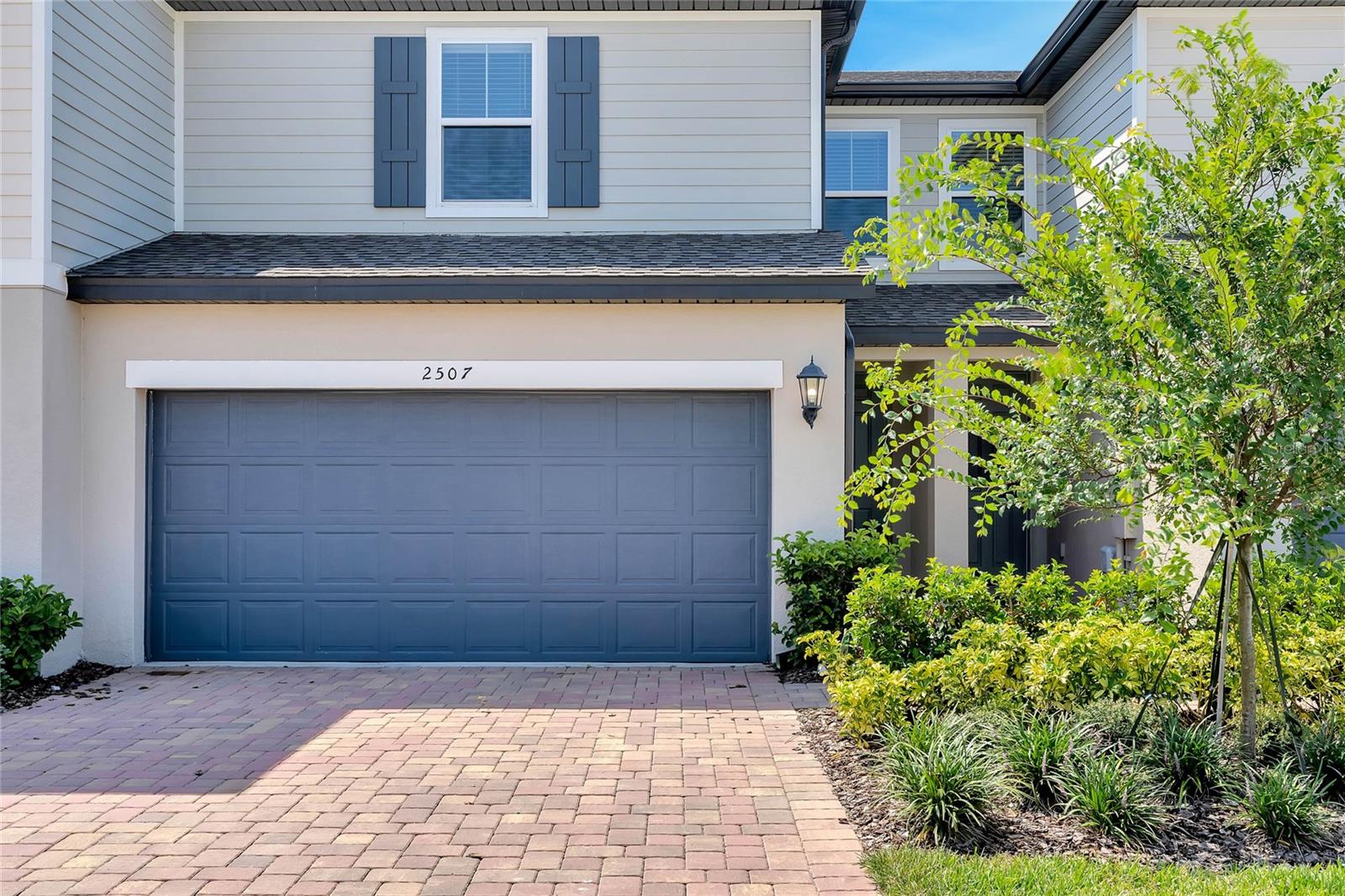 Upon arrival, you'll be greeted by a paver driveway leading to the attached 2-car garage, providing both convenience and style.