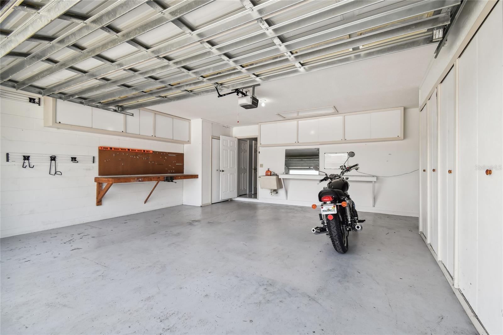 Garage with workbench and storage closets