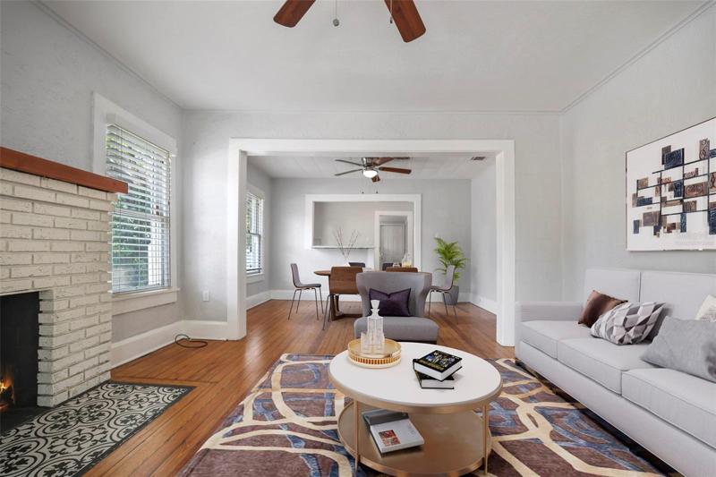 Fireplaced Living Room open to Dining and kitchen. Single Family Home. Virtually Staged
