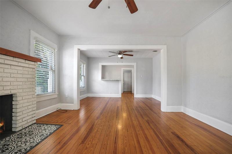 Fireplaced Living Room open to Dining and kitchen. Single Family Home.