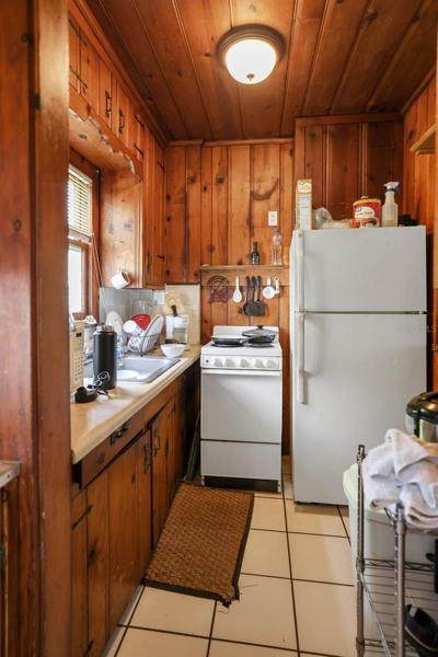 Kitchen upper unit Building 2. Unit has original knotty pine and hardware