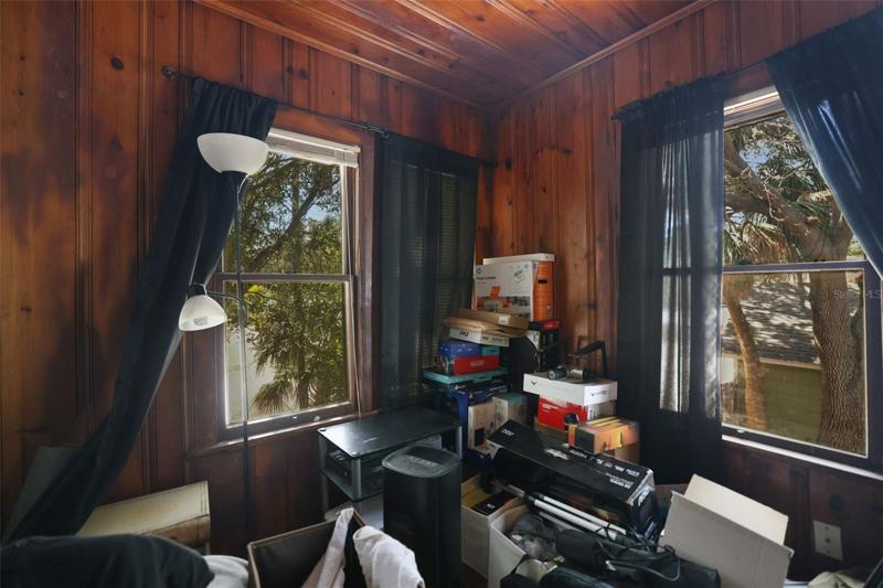 Bedroom 2 upper unit Building 2. Unit has original knotty pine and hardware. current tenant uses for storage