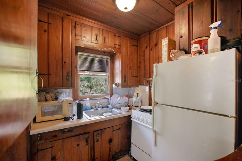 Kitchen upper unit Building 2. Unit has original knotty pine and hardware