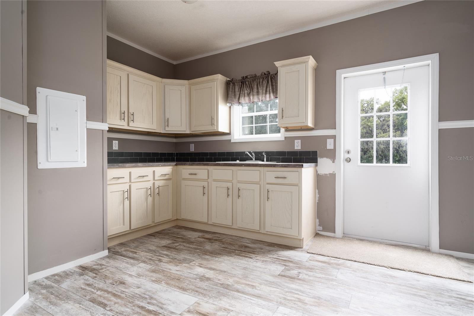 This huge laundry/utility room has a sink and plenty of storage space. Touch up paint from the move is coming.