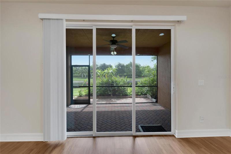 Sliders from Great Room to Screened, Pavered Lanai Overlooking Pond