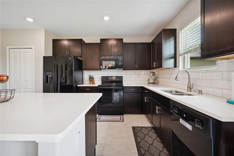 Kitchen with quartz countertops and subway backsplash