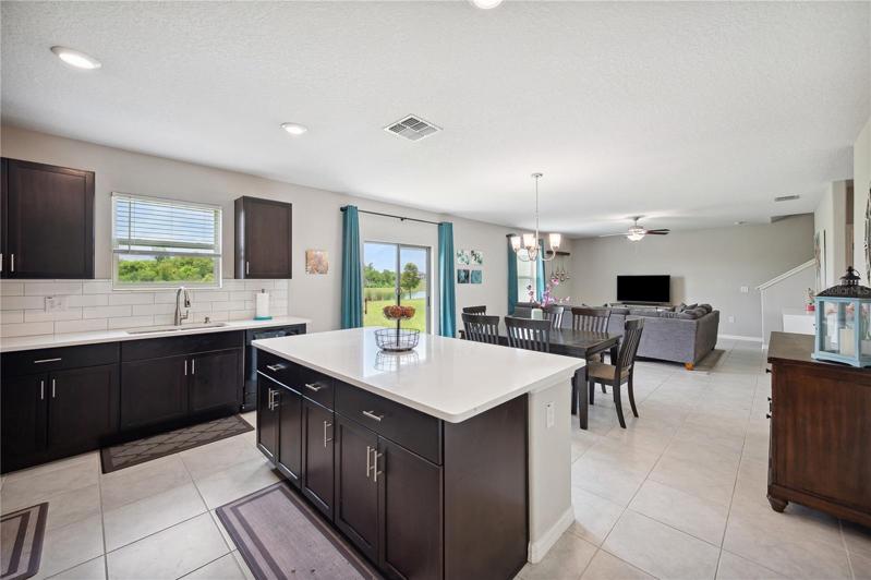 Kitchen with quartz countertops and subway backsplash