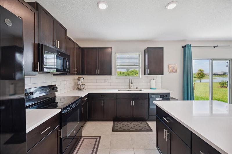 Kitchen with quartz countertops and subway backsplash