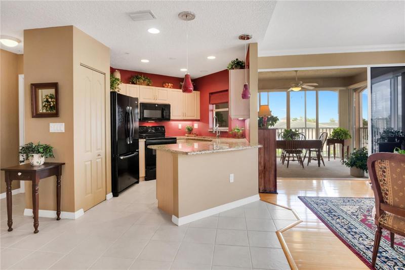 View of kitchen from the hallway that leads to the second bedroom. (primary bedroom is to the left behind the kitchen)