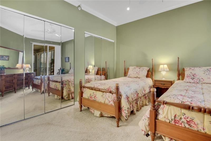 Primary bedroom. Mirror doors of the whole wall of closets
