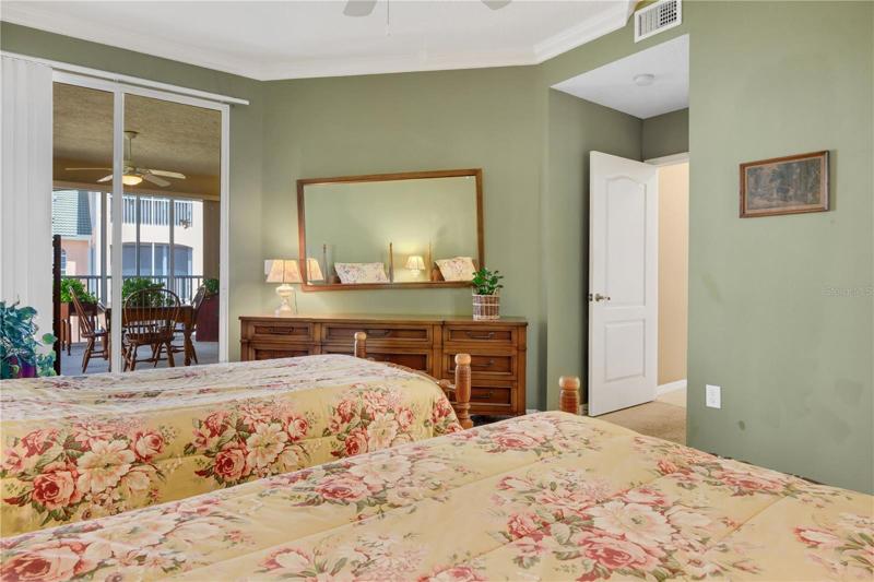 Primary bedroom showing sliders to Florida room