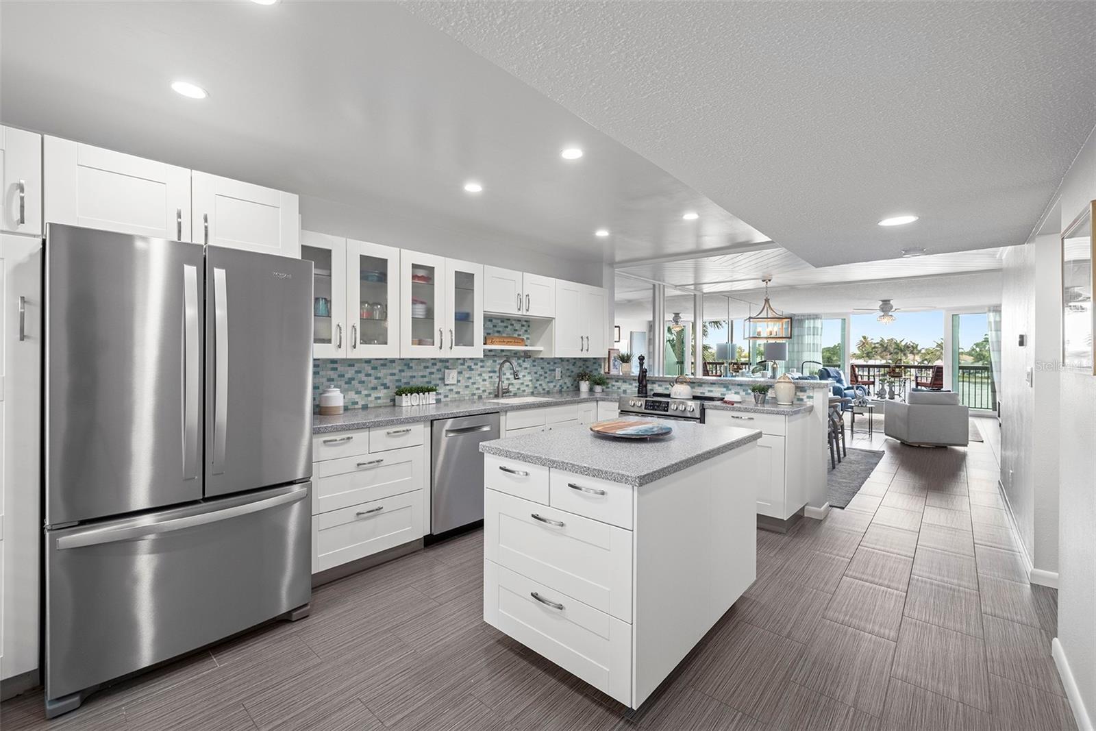 The bright white kitchen looks out into the dining room and living room