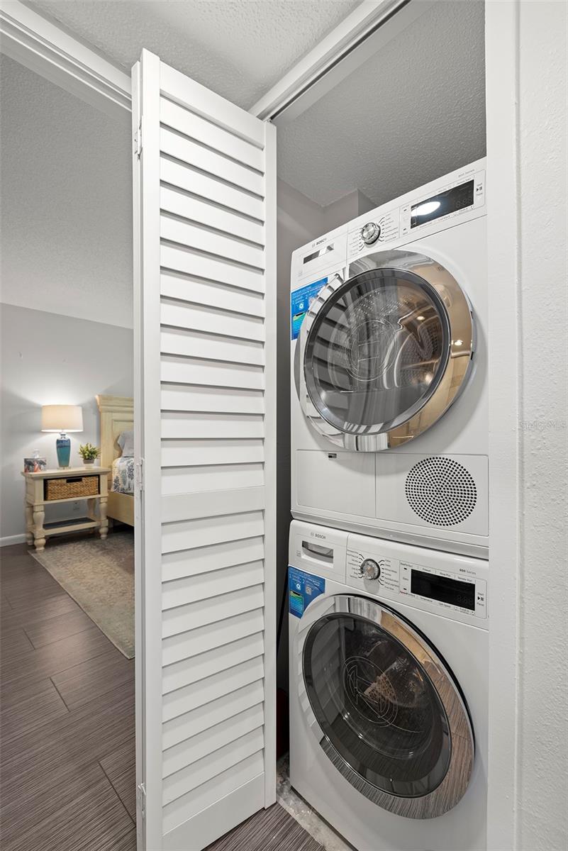 The washer and dryer are located just off the kitchen and across from the second bathroom.
