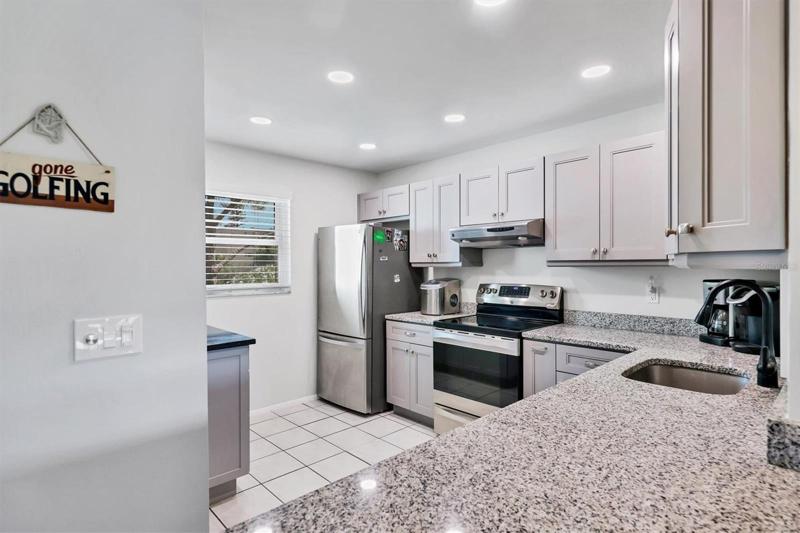 Kitchen with Shaker cabinets and Granite countertops