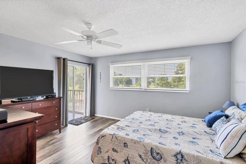 Master Bedroom with Sliding glass doors out to Lanai and view of the Golf Course