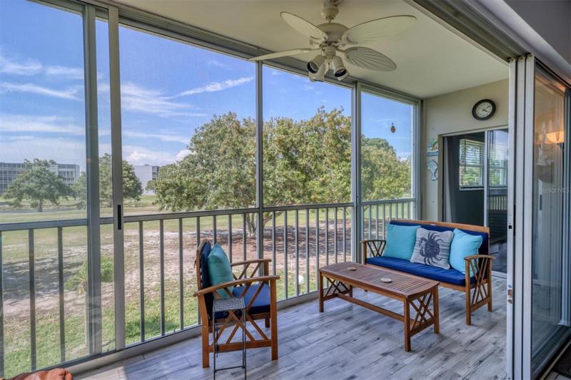 Screened in Lanai with new tiled floors and view of the First Fairway